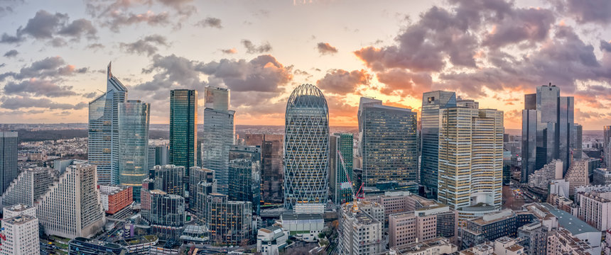 Aerial panoramic drone shot of La Defense skycraper in Paris CBD skyscraper complex business district with clouds during sunset