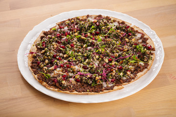 Organic homemade manakish with quinoa, pomegranate vegan dish. Perfect for vegetarians. Food photography concept for delivery and takeaway.