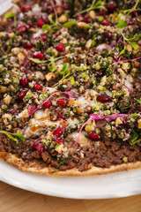 Organic homemade manakish with quinoa, pomegranate vegan dish. Perfect for vegetarians. Food photography concept for delivery and takeaway.