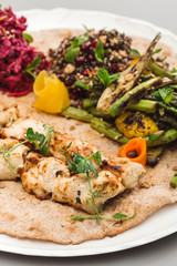 Grilled chicken tikka yoghurt with salad side dish. beetroot, asparagus, and quinoa. Perfect for healthy living vegetarian. Organic food photography concept.