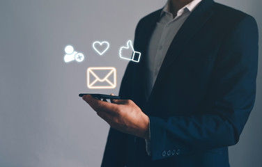 Businessman  holding phone with icon mobile phone, mail, commnet, follower, like, love and address. Customer service call center  concept