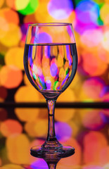 Wine glass reflection with colorful pattern and Bokeh reflection