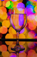 Wine glass reflection with colorful pattern and Bokeh reflection