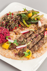 Delicious homemade kebab with salad side dish. beetroot, asparagus, and quinoa. Organic food photography takeaway and delivery concept.