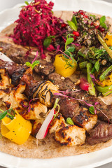 Delicious homemade kebab and chicken tikka salad side dish. beetroot, asparagus, and quinoa. Organic food photography.