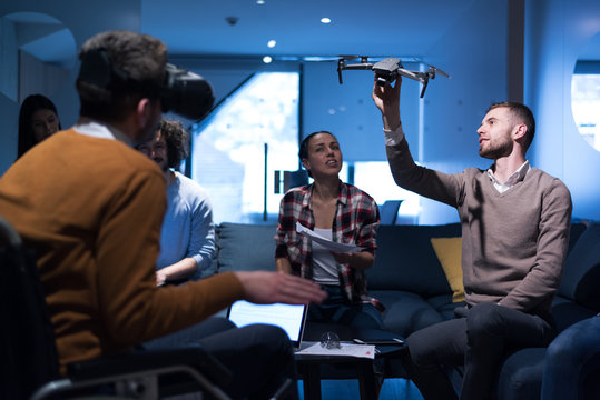 Diverse group of architects working in coworking office using modern technology. Startup people in office working on drone technology. - Powered by Adobe