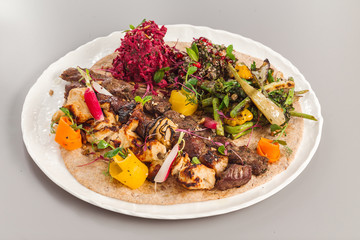 Delicious homemade kebab and chicken tikka salad side dish. beetroot, asparagus, and quinoa. Organic food photography focus view.