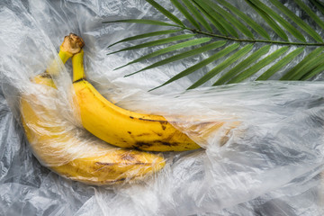 yellow ripe bananas with a plastic film polyethylene abstraction