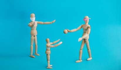 Concept - ban on ball games with children during quarantine. Group of wooden little men mannequins....