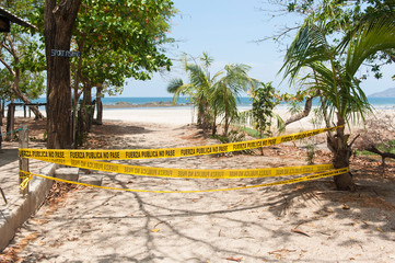 Entrance to Tamarindo Beach blocked with police tape during Covid-19 - Powered by Adobe
