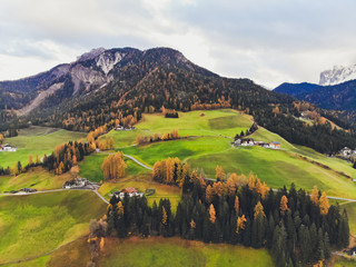 Sunset over the peaks of Puez Odle Nature Park in South Tyrol, Italy. the village of San Pietro.
