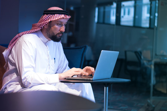 Middle Eastern Businessman Typing On The Phone In His Office. Businessman Arabic Using Mobile Phone For Connection To Communication.Business Technology Concept.