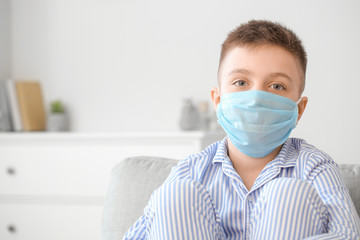 Little boy wearing protective mask at home. Concept of epidemic