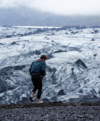 Fototapeta premium model exploring foggy iceberg in Iceland, unusual unique landscape