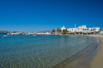 Fototapeta premium The beach and fishing village of Pollonia with fishing boats in sea. Pollonia town, Milos island, Greece