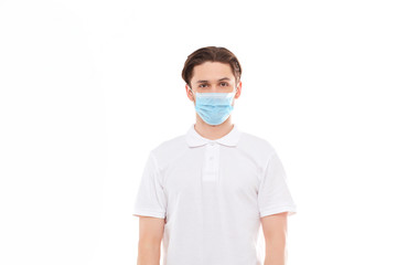 A man in a white T-shirt of European appearance in a medical mask. Covid 19 virus protection.
