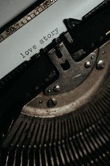 Typing "love story" on retro typewriter
