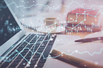 Double exposure of financial chart drawing and desktop with coffee and items on table background. Concept of forex market trading