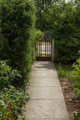 The concrete footpath leads to the gate. Private yard