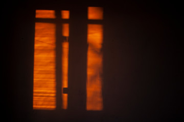 The shadow of the window on the wall in the morning.