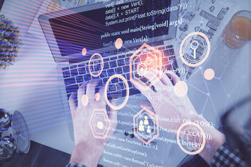 Double exposure of man's hands typing over computer keyboard and data theme hologram drawing. Top view. Technology concept.