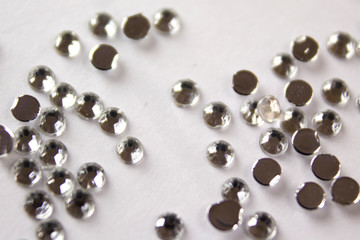 holiday background. decorative shiny rhinestones for makeup and manicure. Decoration of extension nails and manicure. Decorative stones for face and body decoration
