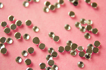 holiday background. decorative shiny rhinestones for makeup and manicure. Decoration of extension nails and manicure. Decorative stones for face and body decoration