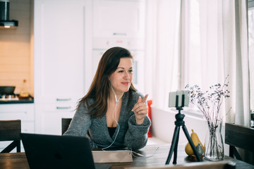 A woman works, conducts live broadcasts from home on the Internet