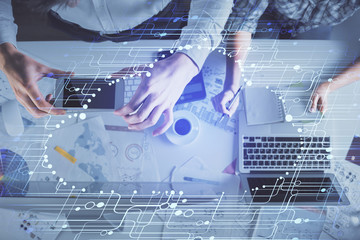 Double exposure of man and woman working together and data theme hologram drawing. Computer background. Top View.
