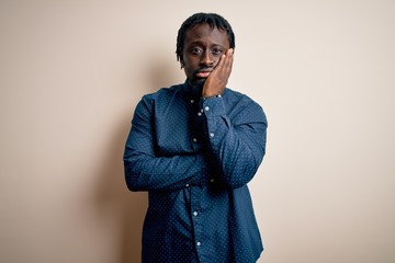 Fototapeta premium Young handsome african american man wearing casual shirt standing over white background thinking looking tired and bored with depression problems with crossed arms.