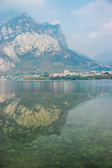 San Martino mountain and Bergamo Alps reflect in the water of Lake Como near the village of Lecco, Lombardy, Northern Italy