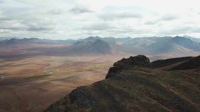 Hiker walking alone with stunning views of the Dempster highway in the Yukon