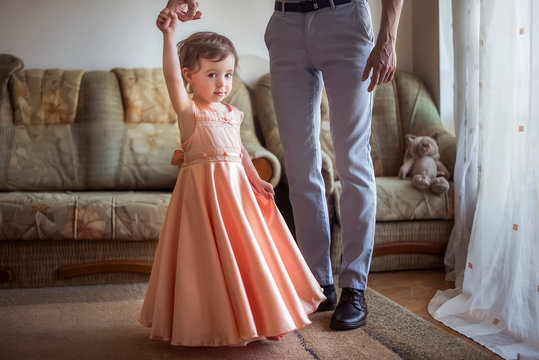 First Daughter Dance With Dad. Little Girl Dancing On Daddy's Legs. Relations Between Dad And Daughter.