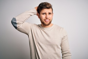 Fototapeta premium Young handsome blond man with beard and blue eyes wearing casual sweater confuse and wonder about question. Uncertain with doubt, thinking with hand on head. Pensive concept.