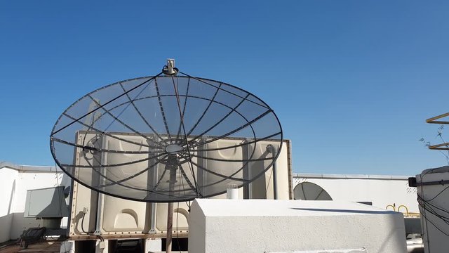 Building with attached satellite dishes for receiving TV or radio signal