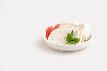 Halloumi cheese in white bowl
