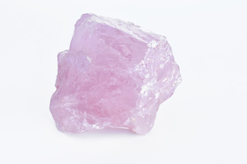 A close up image of a raw rose quartz crystal. 