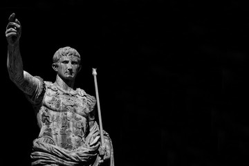 Caesar Augustus, first emperor of Ancient Rome and father of the nation. Old bronze statue along the Imperial Forum Road (Black and White with copy space)