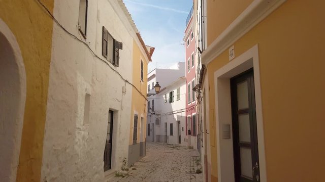 Walking in antique town of Ciutadella de Menorca. Beautiful narrow street with colorful architecture houses 60fps. Balearic Island, Menorca, Spain.
