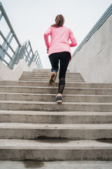 Sport woman running on stairs.