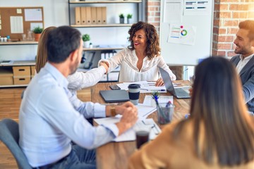 Group of business workers smiling happy and confident. Working together with smile on face shaking hands at the office