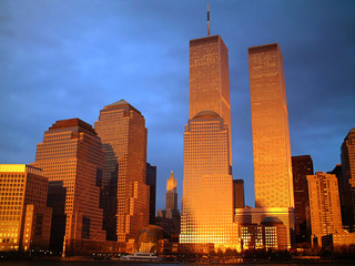 Illuminated World Trade Center And Buildings Against Blue Sky At Dusk