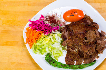 Gyro kebab with salad and rice on plate 