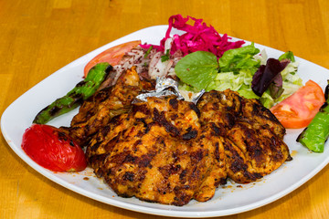 Turkish cuisine. Chicken chop on bone (pirzola) with vegetables
