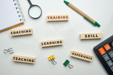 Training concept - wooden blocks with inscriptions coaching, learning, skill, teaching.