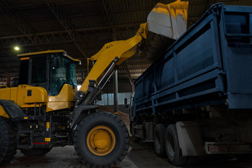 Loading a truck with cargo using a wheel loader, bucket.