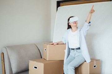 Asian young girl using VR glasses at home