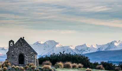 Small church with mountain backdrop shot during sunrise at Lake Tekapo, New Zealand