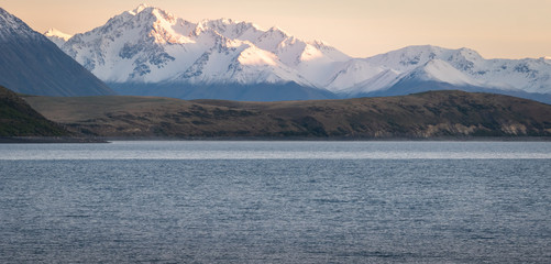 Mountain range during sunrise with lake in foreground, shot at Lake Tekapo, New Zealand