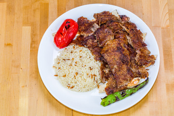 Gyro kebab with salad and rice on plate 